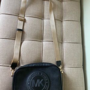 Michael Kors crossbody bag. Black leather with gold strap. Good condition.